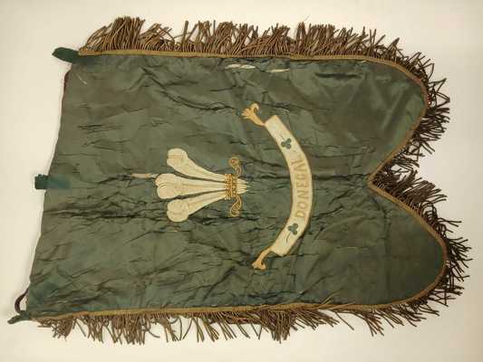 This silk bannerette from the Donegal Militia is from the early 19th century and its acquisition was supported by the Friends of the National Collections of Ireland. The Donegal Militia (also known as the Prince of Wales's Own Donegal Militia) saw action in the 1798 Rebellion and the Napoleonic Wars. Revived in 1855 after a long period of Militia decline across Ireland, it became known as the Donegal Artillery Militia where it famously fought in the Second Boer War. (DCM.2025.58)